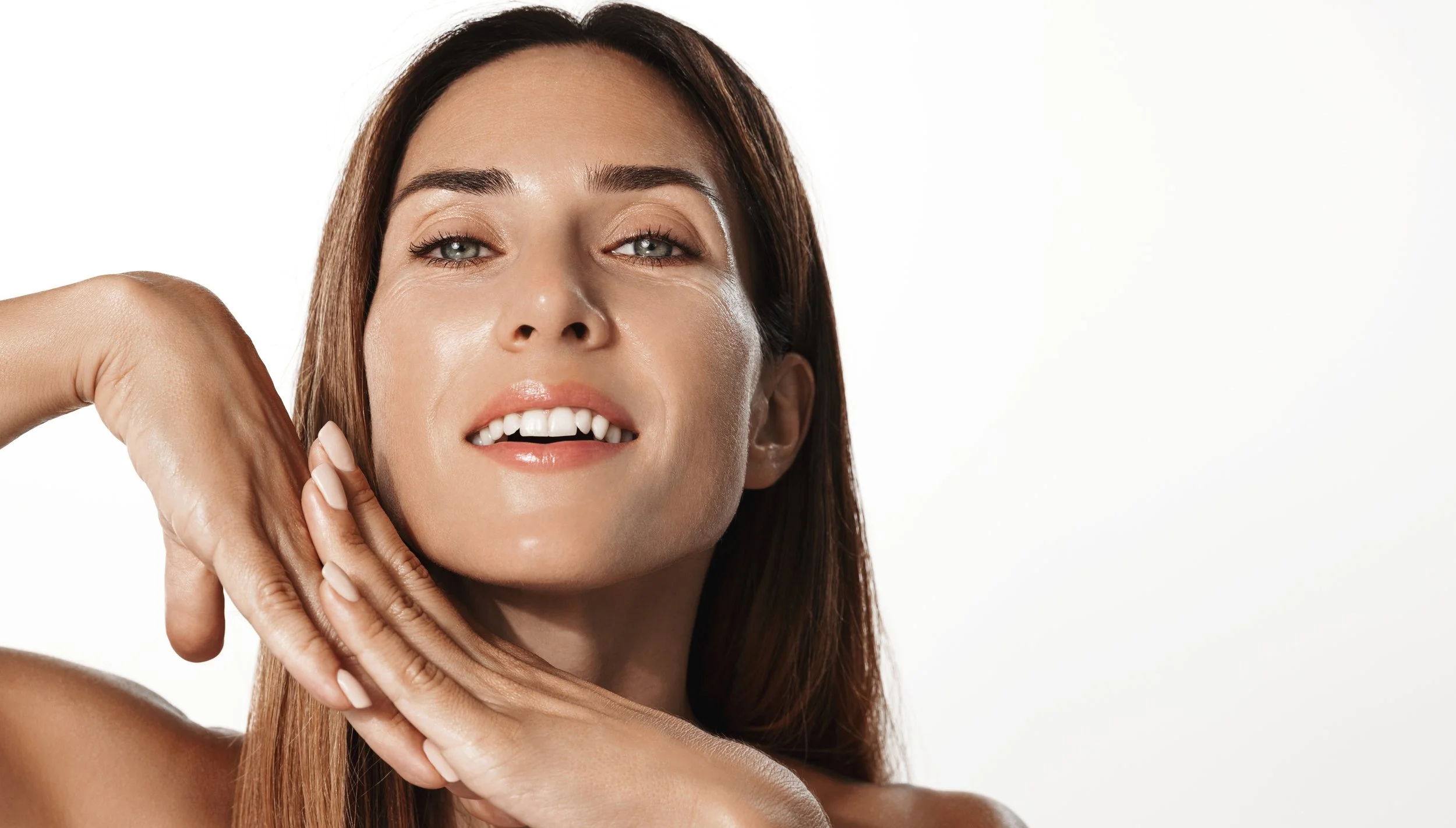 Smiling woman posing with hands under chin