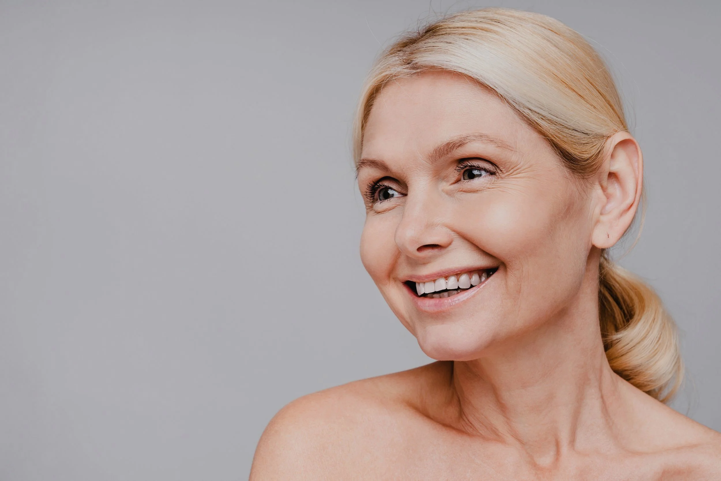Smiling blonde mature woman after neck lift