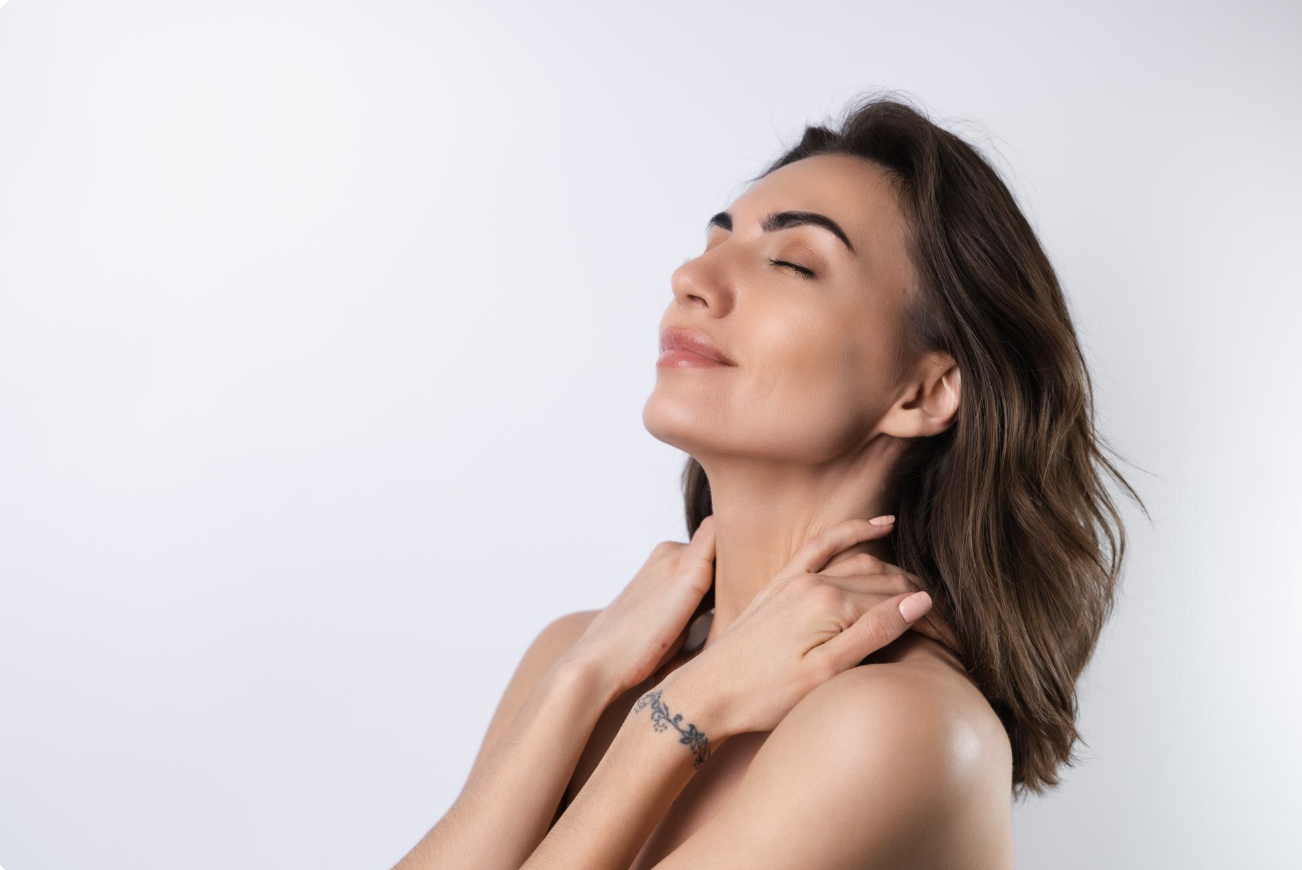 Brunette woman smiling after neck liposuction