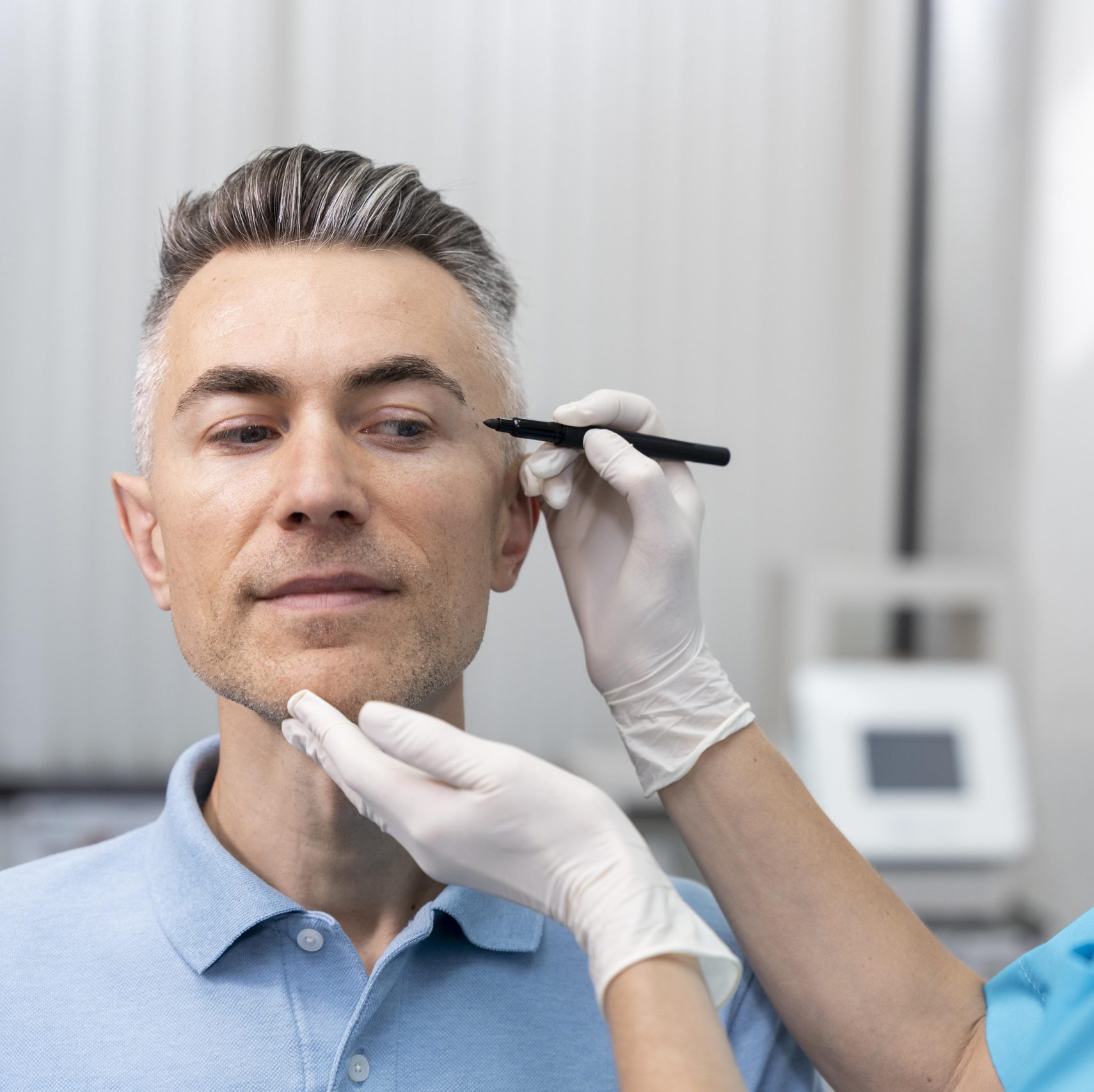 Dr. Misch marking a patient's face ahead of a facial plastic surgery consultation