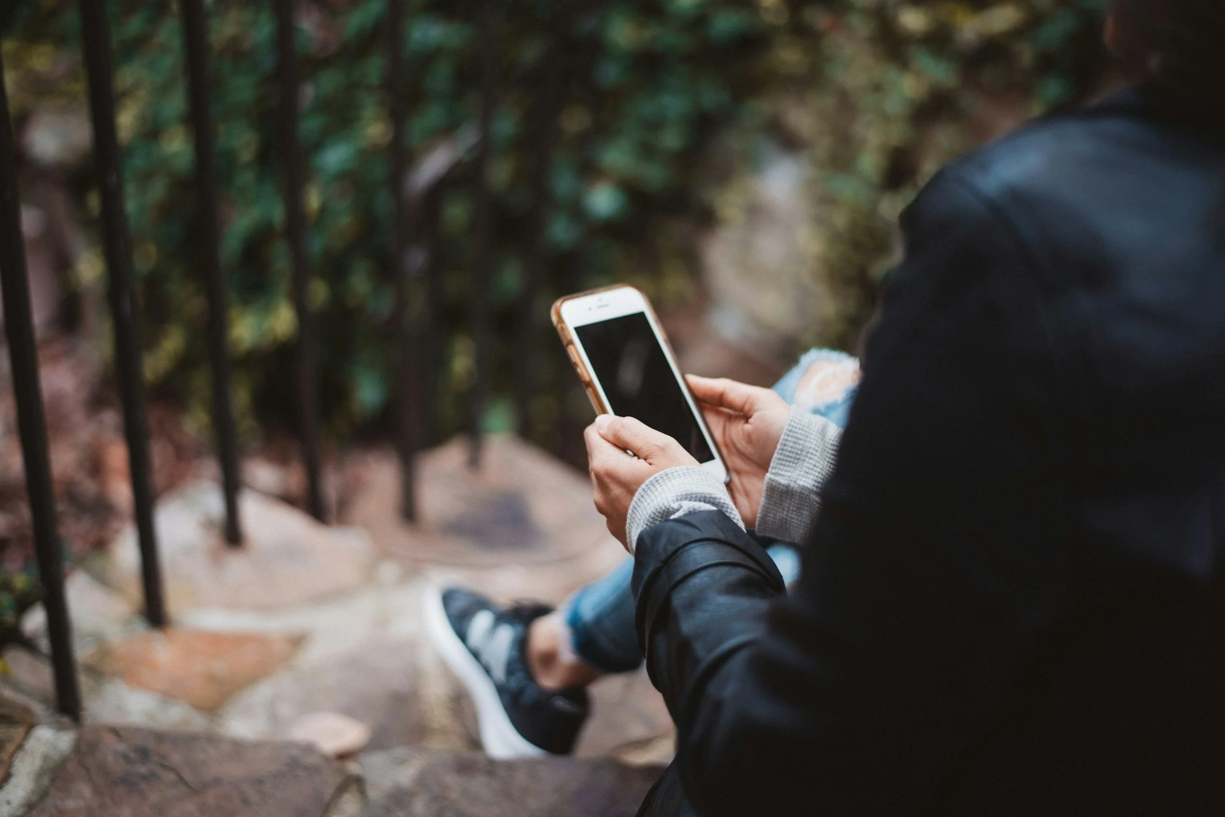 Person using smartphone outdoors – Emily Misch Clinic